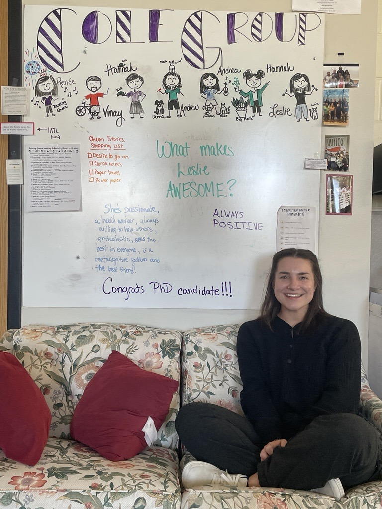 Leslie Sitting in front of Whiteboard