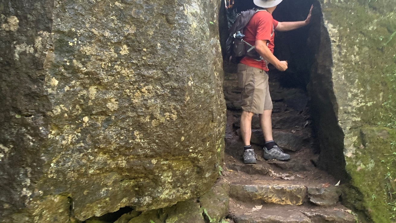 Greg going through a cave