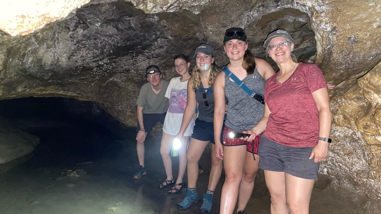 The group posing inside of a cave